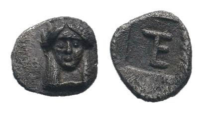 IONIA.Kolophon.Circa 525-490 BC. AR Tetartemorion. Facing head of Apollo / TE mo...