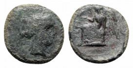 Bruttium, Terina, c. 350-275 BC. Æ (13.5mm, 2.19g, 3h). Female head r. R/ Nike seated l. on cippus, holding bird. HNItaly 2651; SNG ANS -. Green patin...