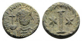 Justinian I (527-565). Æ 10 Nummi (16mm, 6.22g). Rome or Ravenna, 547-549. Helmeted and cuirassed facing bust, holding globus cruciger and shield. R/ ...