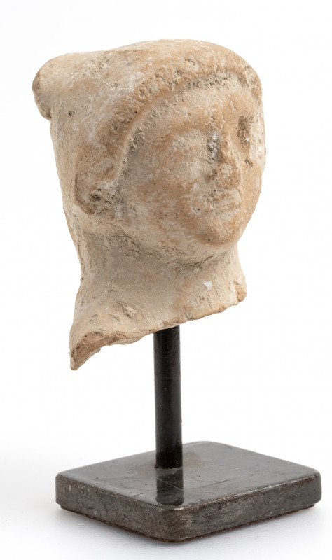 Egyptian Ptolemaic terracotta votive head of a hooded young man; ca. 332 - 32 BC...