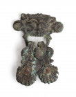A bronze handle of a Greek cista, with head of Satyr facing and two shell pendants; traces of four iron nails attached; ca. 3rd century BC; height cm ...