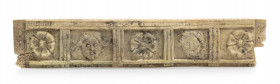 Roman bone applique, probably belonging of a little chest, with fronting female faces (Medusa ?) alternating with flowers, all between triglyphs; very...