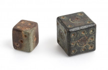 Couple of Roman dice, bone and bronze. Maybe the bronze one was part of an ancient mechanism: it has iron traces on center and don't show logic number...