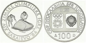 Yugoslavia 100 Dinara 1983 Bobsledding. Averse: Emblem and Olympic logo on separate shields within flat bottom circle. Reverse: Bobsledders. Silver. K...