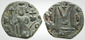 Byzanine 
Imperial Image coinage. Anonymous. Hims (Emesa) mint. (Circa 680).
AE Fals (20mm, 2.7 g,)
Obv :Standing imperial figure, holding long crucif...