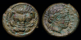 BRUTTIUM, Rhegion, c. 415-387 BCE, AE12 (onkia?). 2.09g, 12mm.
Obv: Lion’s head facing
Rev: PHΓINH; Laureate head of Apollo right, olive sprig behind....