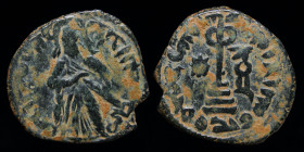 UMAYYAD: 'Abd al-Malik ibn Marwan, AE fals, Standing caliph type, issued c. 690s. Hims/Emesa, 3.46g, 21mm. 
Obv: Caliph standing facing, holding on sh...