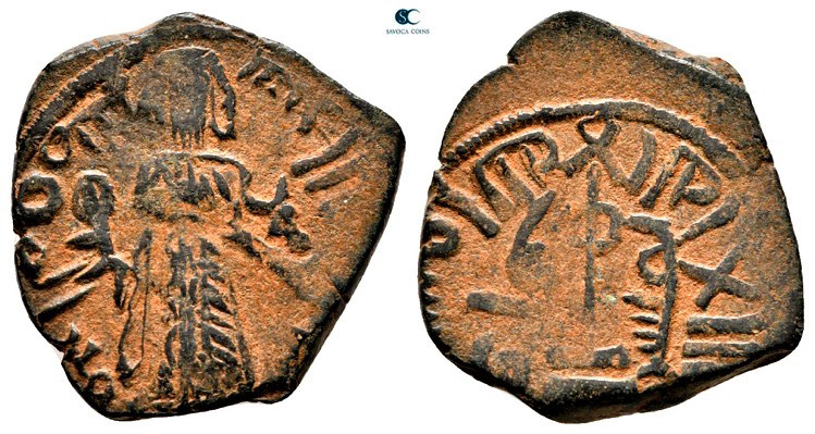 Arab-Byzantine. Qinnasrin. Standing Caliph AD 692-697. 
Fals Bronze

19 mm, 3...