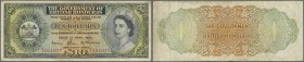 British Honduras: Government of British Honduras 10 Dollars April 1st 1964, P.31b, still a nice note with crisp paper and bright colors, several folds...