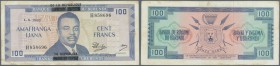 Burundi: 100 Francs 1965 with black overprint P. 17a, used with center fold, light stain in paper, no holes, still strong paper, condition: F+.