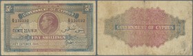 Cyprus: 5 Shillings 1945, P.22 in used condition with several folds, staining paper and small tear at upper margin. Condition: F-