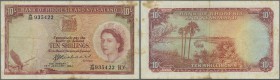 Rhodesia & Nyasaland: 10 Shillings 1961 P. 20, used with folds and stain in paper, 2 pinholes, no tears, still nice colors, condition: F.