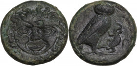 Sicily. Kamarina. AE Tetras, c. 420-405 BC. Obv. Gorgoneion. Rev. [KAMA] Owl standing right, holding lizard; Γ in right field; in exergue, three pelle...