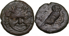 Sicily. Kamarina. AE Tetras or Trionkion, c. 420-405 BC. Obv. Gorgoneion facing. Rev. KAMA. Owl standing right, head facing, grasping lizard; in exerg...