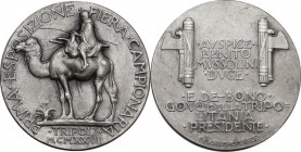 Medaglia 1927 per la Prima Esposizione della Fiera Campionaria di Tripoli. AG. 33.00 mm. Opus: P. Morbiducci. RR. SPL.