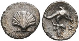 CALABRIA. Tarentum. Circa 325-280 BC. Hemilitron (Silver, 8 mm, 0.31 g, 10 h). Scallop shell. Rev. Dolphin right; below, Athena Promachos standing rig...