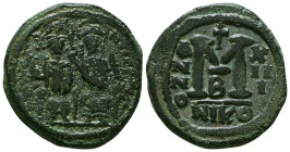 Justin II, with Sophia Æ Follis. Nicomedia, AD 568-569. Justin, holding globus cruciger, and Sophia, holding cruciform sceptre, seated facing on doubl...