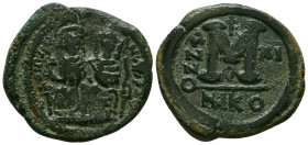 Justin II, with Sophia Æ Follis. Nicomedia, AD 568-569. Justin, holding globus cruciger, and Sophia, holding cruciform sceptre, seated facing on doubl...