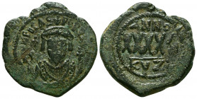 PHOCAS. 602-610 AD. Æ Follis . Cyzicus mint. Dated year 4 (605/6 AD). Crowned facing bust, wearing consular garb, holding mappa and cross; cross in le...