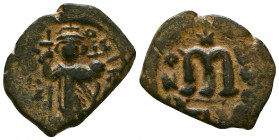 Arab-Byzantine, Mu'awiya, 660-680. Æ Fals. Standing imperial figure, holding long cross and globus cruciger. R/ Large M; cross above, star below.
Refe...