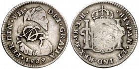México. (De Mey 898) (Kr. 272.1). 3,28 g. Resello monograma del general José Francisco Osorno. Sobre 1 real de México 1809 TH, busto imaginario. Rara....