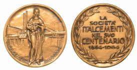 BERGAMO. Società Italcementi. Medaglia in bronzo per il 100° Anniversario (1864-1964). Figura femminile stante regge composizione vegetale; sullo sfon...