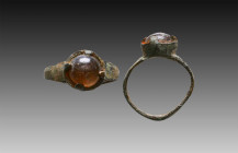 Ancient Bronze Ring with a stone on bezel. 7th and 12th century AD

Weight: 2.2 gr
Diameter: 21 mm
