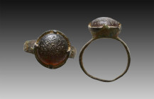 Ancient Bronze Ring with a stone on bezel. 7th and 12th century AD

Weight: 3.8 gr
Diameter: 24 mm