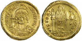 BYZANTINE EMPIRE: Justinian I, 527-565, AV solidus (4.29g), Constantinople, S-140, helmeted and cuirassed bust, holding globus cruciger & shield // an...