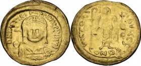 Justinian I (527-565). AV Solidus, Constantinople mint, 542-552. Obv. Helmeted and cuirassed bust facing, holding globus cruciger. Rev. Victory standi...