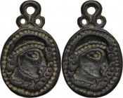 Bronze applique with face. Migration period, 5th-7th century AD. 32 x 20 mm.