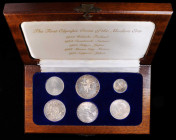 MIXED LOTS. Sextet of Silver Olympic Issues (6 Pieces), 1952-72. Average Grade: UNCIRCULATED.

A wooden display case with Olympic-themed coins from ...