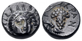 CARIA. Kranaos. Circa 300-280 BC. Chalkous (Bronze, 10 mm, 1.71 g, 6 h). Radiate and draped bust of Helios facing slightly to right. Rev. KPAN Grape b...