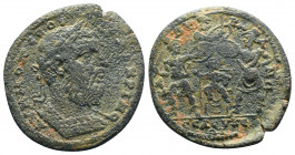Macrinus of Seleucia ad Calycadnum, Cilicia. AD 217-218. Ae. Laureate and cuirassed bust right; counter-mark: small o within Δ / The infant Zeus seate...