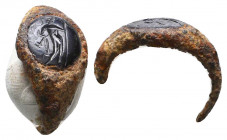 Roman Bronze Ring With Intaglio, Circa 1st - 2nd Century AD.
The bezel contains a dark gem, which is finely carved to depict a male.

Weight: 3.2 g...