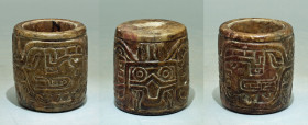 A rare Chavin stone cup from Peru, ca. 1200 - 200 B.C. It is 2? high and is elaborately decorated with four deeply incised deity heads. Intact.