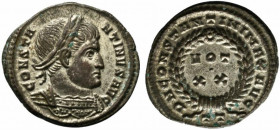 Constantine I (307/310-337). Æ Follis (19.5mm, 3.17g, 6h). Ticinum, 322-5. Laureate and cuirassed bust r. R/ VOT/XX in two lines within laurel wreath;...