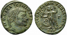 Licinius I (308-324). Æ Follis (22mm, 2.96g, 11h). Siscia, 313-5. Laureate head r. R/ Jupiter standing l., holding globe surmounted by Victory, leanin...