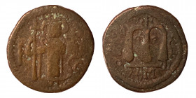 Umayyad Caliphate, circa 680s-700/10. Æ Fals (bronze, 3.39 g, 18.50 mm). Emperor standing facing, holding long cross and globus cruciger. Rev. Large m...