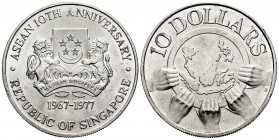 Singapour. 10 dollars. 1977. (Km-16). Ag. 30,91 g. Asean 10th Anniversary. Mint state. Est...25,00. 

Spanish Description: Singapur. 10 dollars. 197...