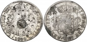 Resello F7º bajo corona sobre 8 reales de México F(T) de 1802. 26,81 g. Pequeños resellos orientales. Ex Áureo 16/12/2004, nº 859. Rara. BC+.