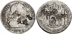 1778. Carlos III. Lima. MJ. 2 reales. 6,75 g. Varios resellos orientales grandes en ambas caras. BC+.