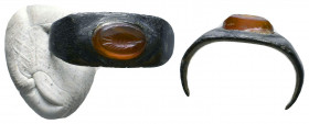 Roman Bronze Ring with a red stone and Fish on Bezel , Circa 1st - 2nd Century AD.

Weight: 1.9 gr
Diameter: 18 mm
