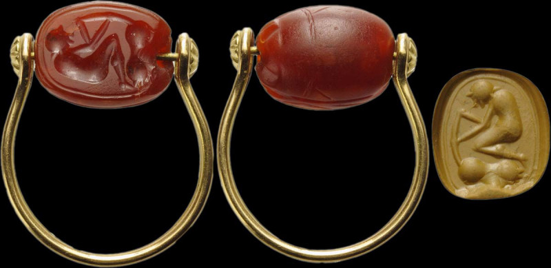 An etruscan carnelian scarab intaglio set on a modern gold ring. Male figure and...