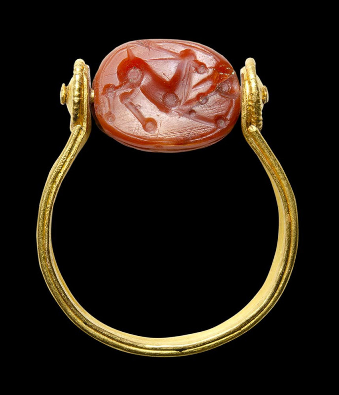 An etruscan agate scarab intaglio set in a postclassical swivel gold ring. Antel...