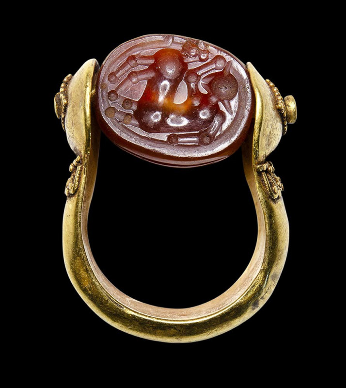 An etruscan agate scarab intaglio set in a gold swivel ring. Centaur.

4th cen...
