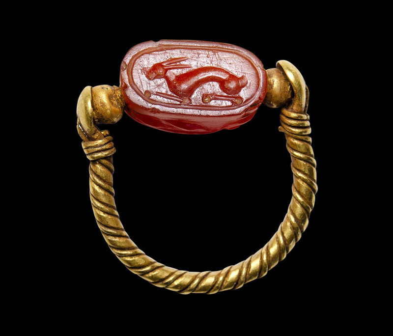 An etruscan agate scarab intaglio set in a swivel gold ring. Hare.

4th centur...