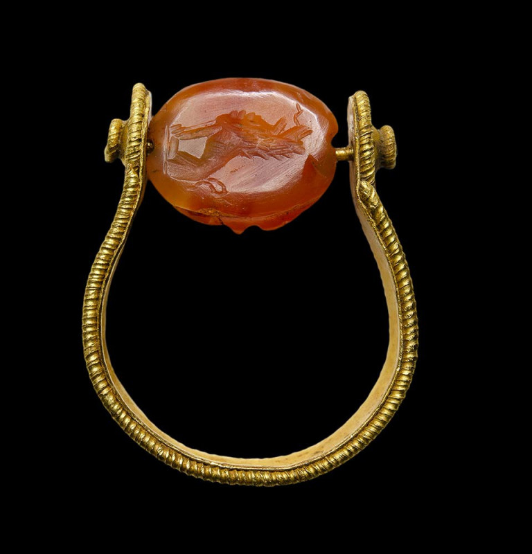A late archaic etruscan gold swivel ring with a roman carnelian engraved scarab....