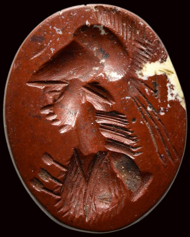 A roman red jasper intaglio. Bust of Athena. 

3rd century A.D.
10x13x2,5 mm...