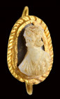 A roman two-layered onyx cameo set in an antique gold earring.
